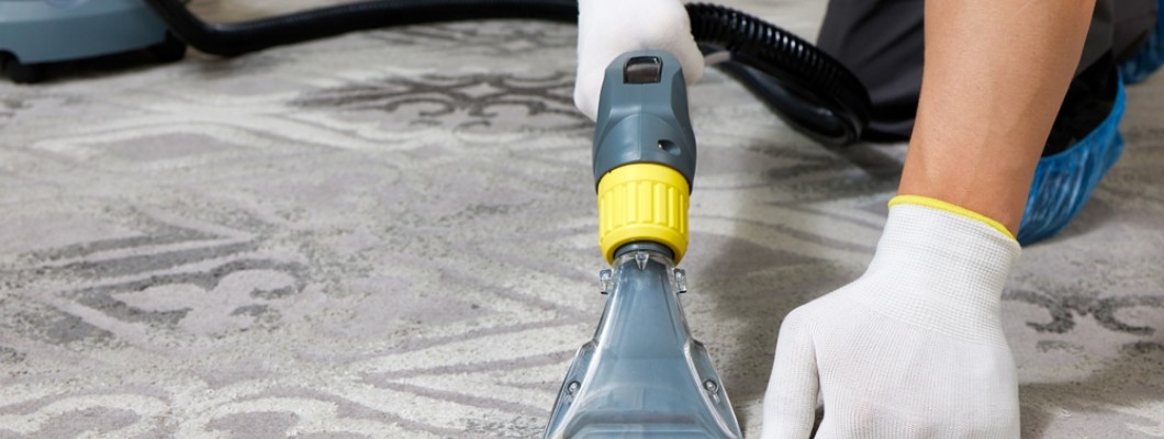 Persoana care curata mocheta cu o solutie speciala Persoana care curata mocheta cu o solutie speciala